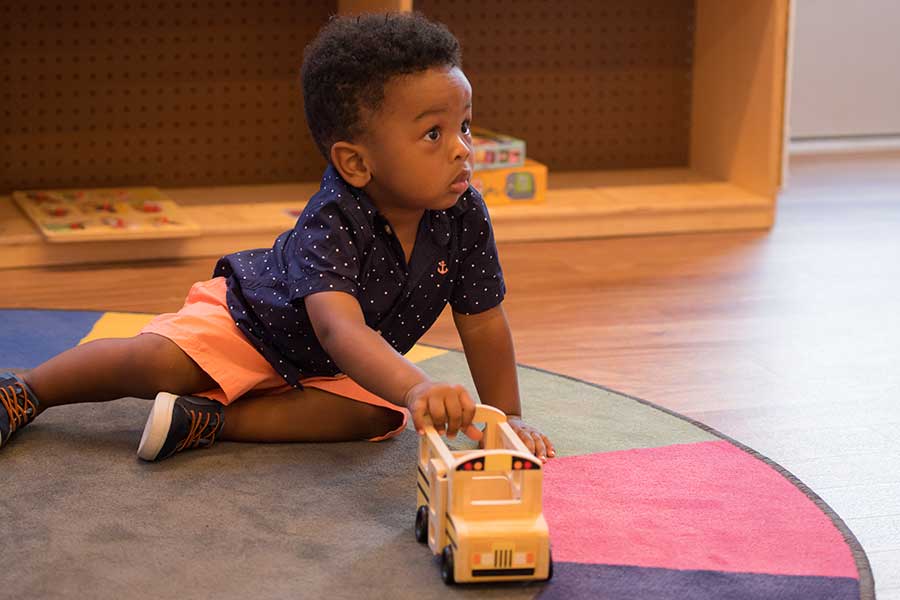 Child playing with a truck