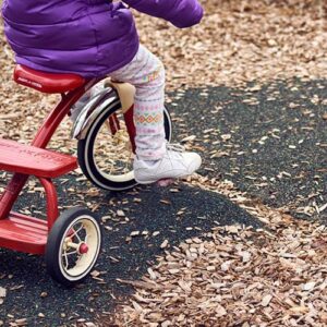 A child rides a tricycle